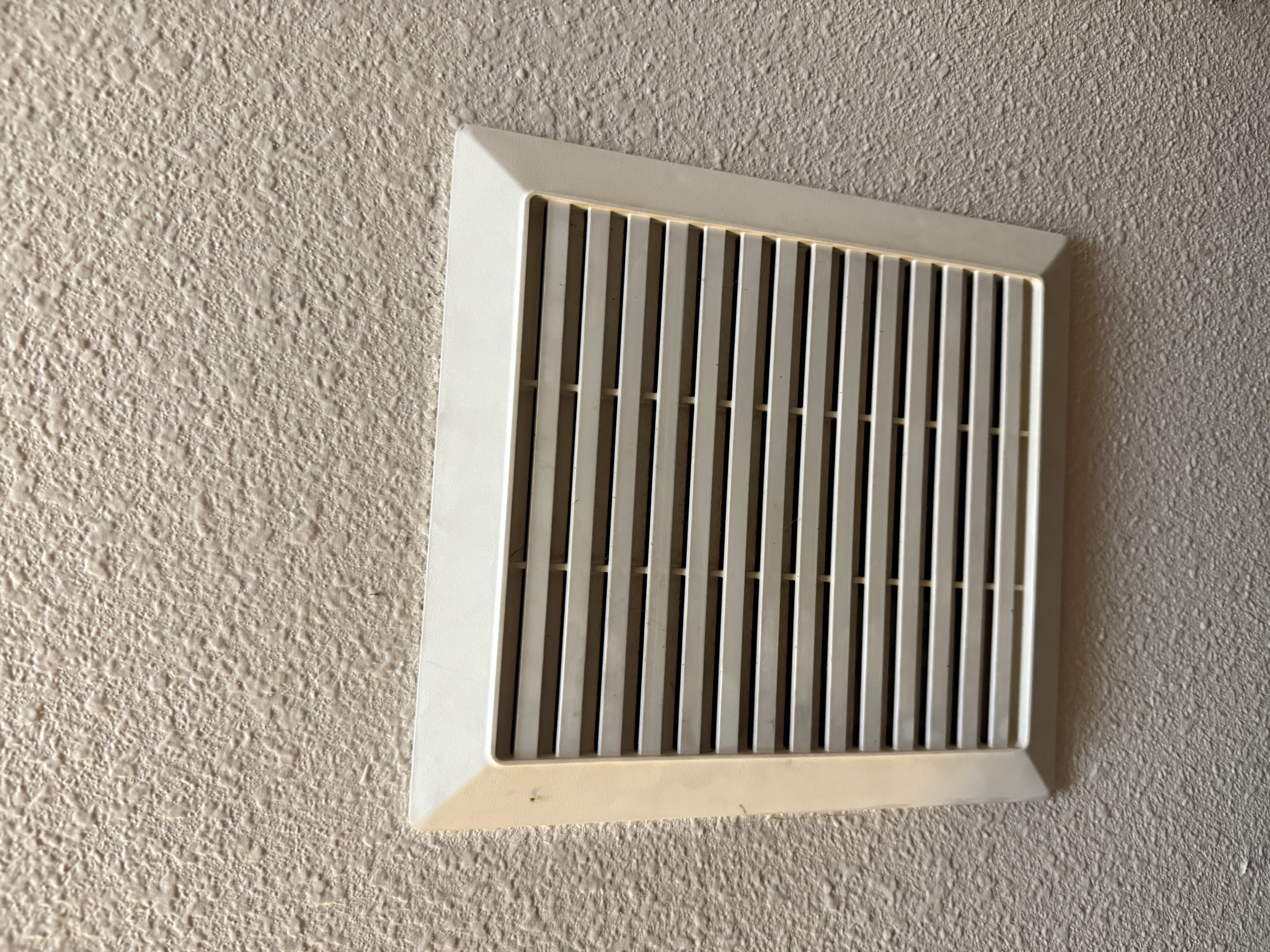 Clean bathroom ceiling with the new fan installed