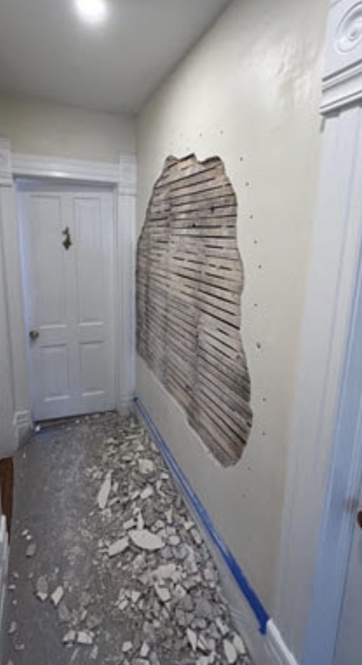 Damaged wall before the drywall patch
