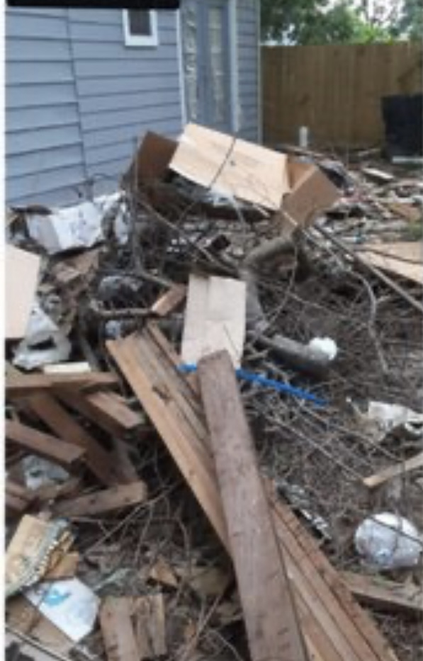 Cluttered yard before the landscaping and junk removal work